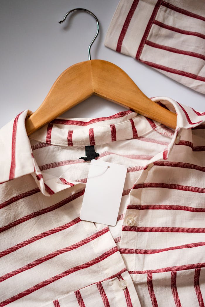 Home Close-up of a red and white striped shirt on a wooden hanger.
