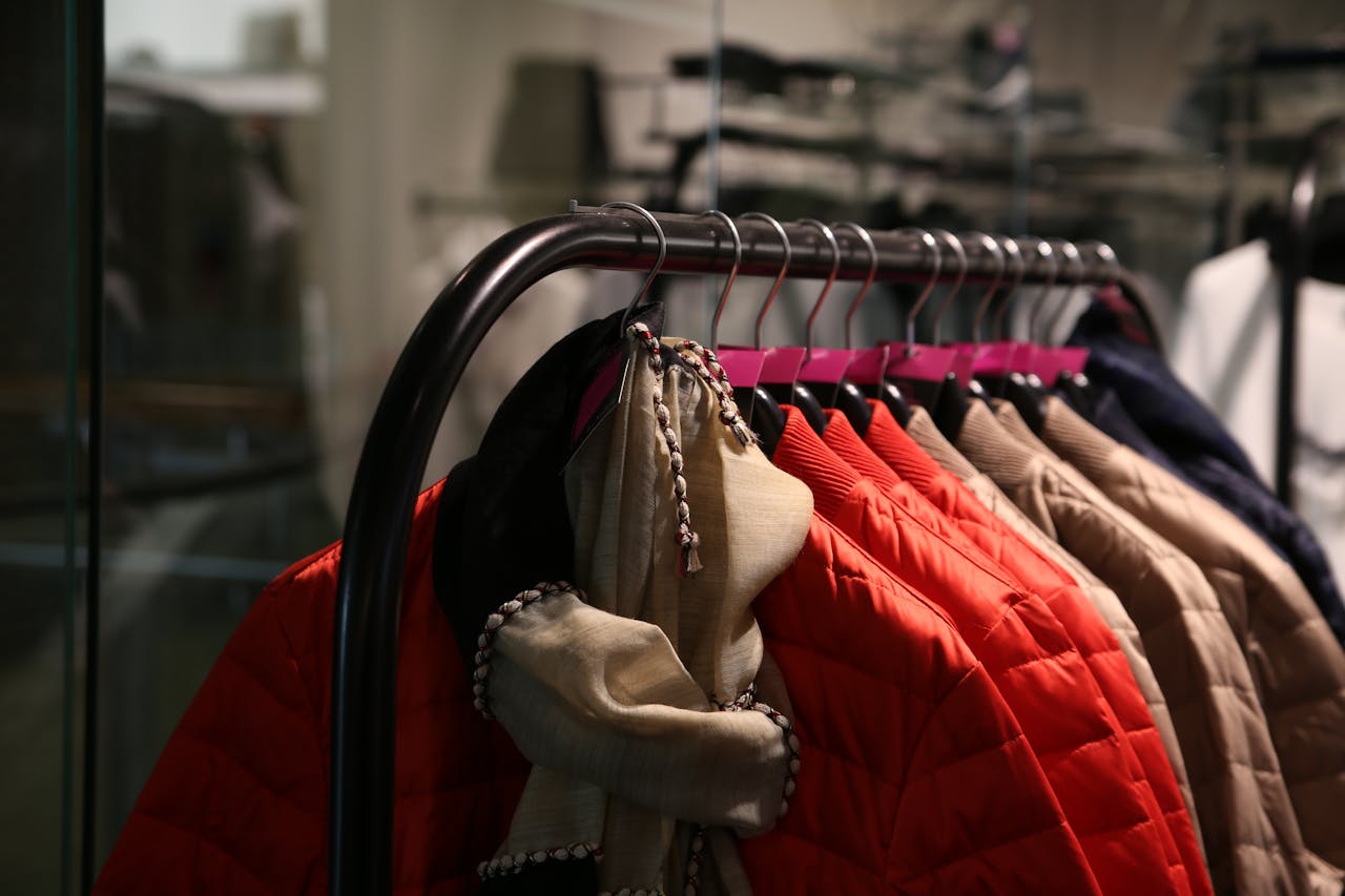 Home A variety of colorful jackets hanging on a clothes rack in a stylish store.